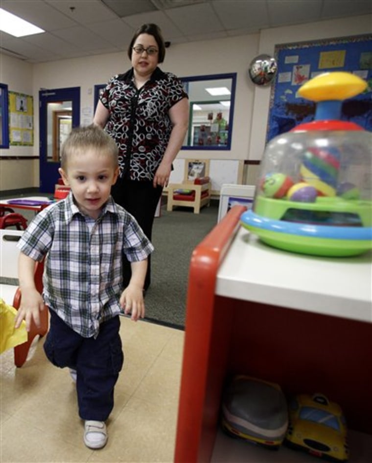In this April 4, 2012, photo, Kelly Andrus follows her son Bradley as he runs through a classroom at Children's Choice Learning Centers Inc., where Bradley attends in Lewisville, Texas. Bradley, who turns three in a couple of weeks, was diagnosed a year ago with mild autism. For the first time in nearly two decades, experts want to rewrite the definition of autism. Some parents fear that if it's narrowed and their kids lose the label, they may also lose out on special therapist. (AP Photo/Tony Gutierrez)